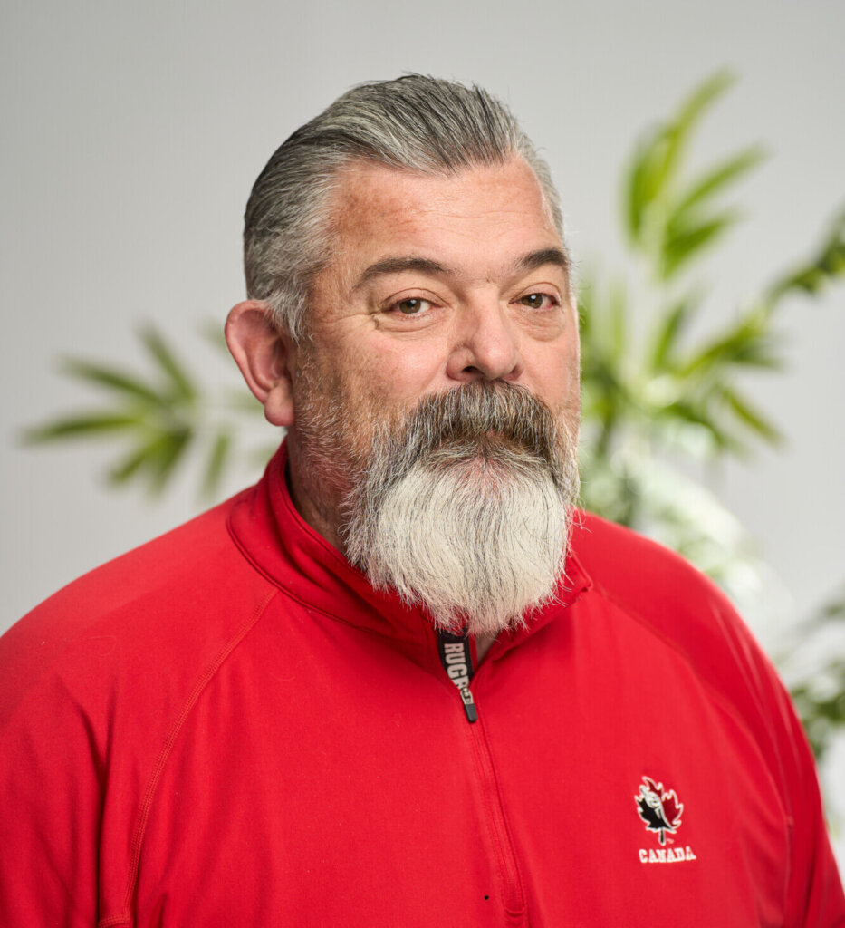 A headshot of Geoff VanMackelbergh smiling
