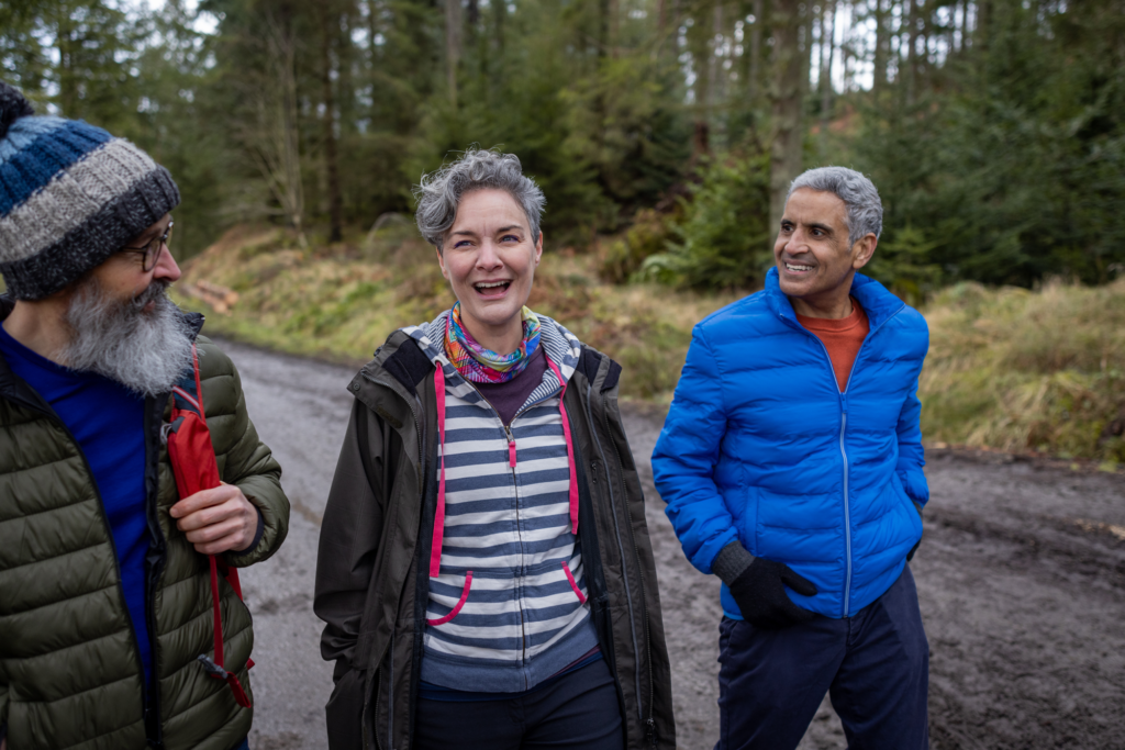 Three older adults going for a walk in spring